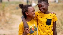Two girls wearing yellow walking together 
