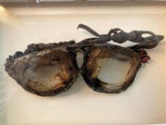 A pair of old broken glasses