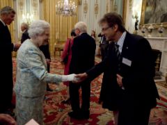 A man greeting the queen in the palace.