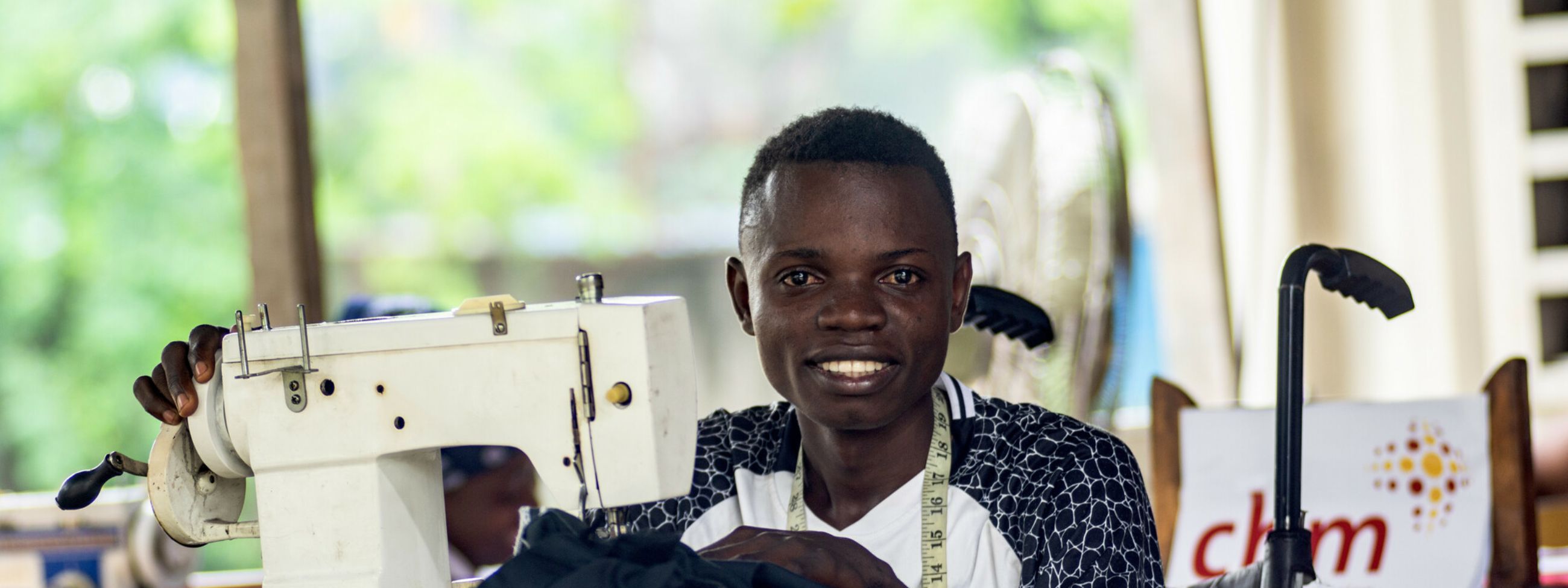 Jordan, a 25-year-old with a leg disability from wild poliomyelitis due to lacking vaccination, was identified at a Catholic parish through a CBM-funded project in Congo. He is now enrolled in a sewing training center.