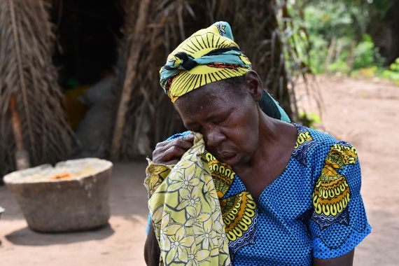 A woman cleaning tears from her eyes
