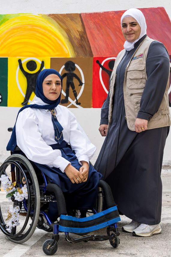 There are two women in the picture, and the woman on the right is a wheelchair user.