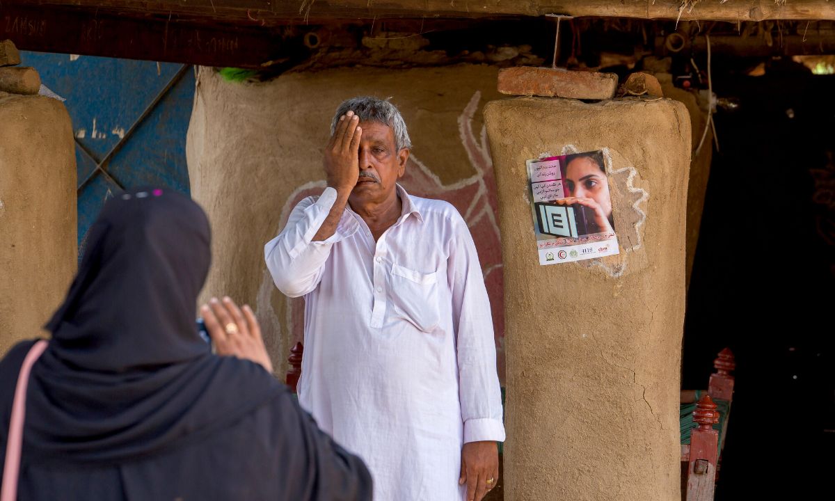 Gagan, 63, undergoes eye screening using the Peek mobile app provided by CBM in Matiari, Hyderabad, Sindh, Pakistan. CBM aims to enhance access to inclusive and comprehensive eye health services in Pakistan through partnerships.