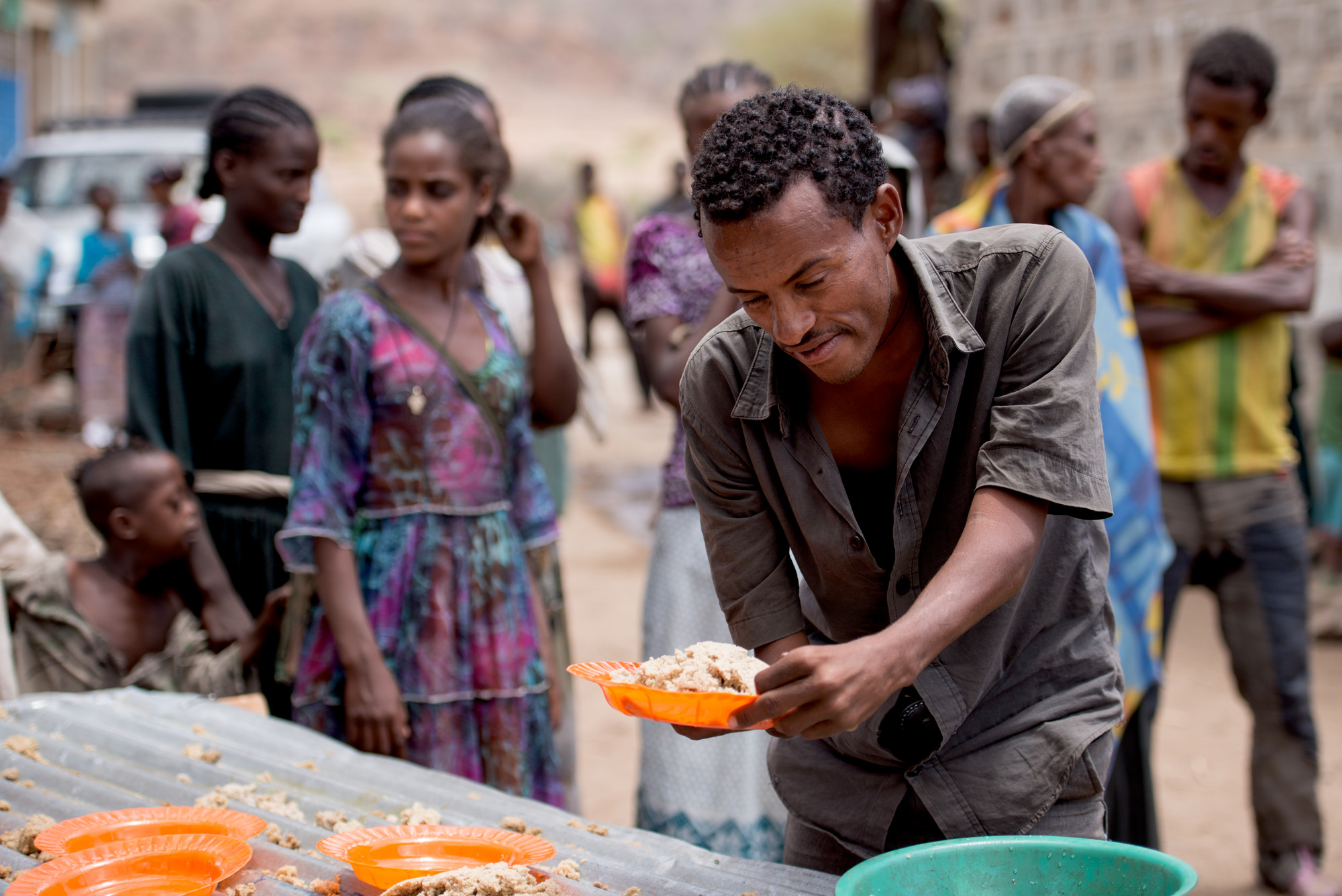 A community member with a physical impairment is allowed to eat at Tartuarwa Primary School in the East Belessa district of Ethiopia on May 17, 2016. Students and other community members with disabilities receive a daily meal and water through a school feeding and water distribution program funded by CBM.