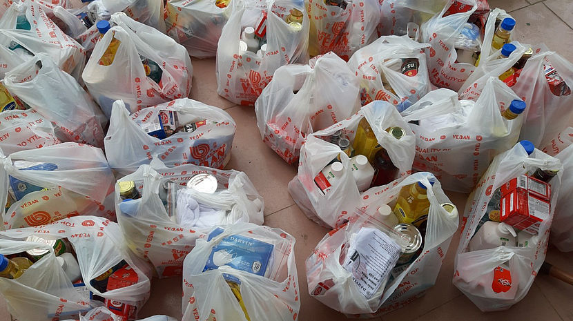 This photo shows bags filled with food items and hygiene material.
