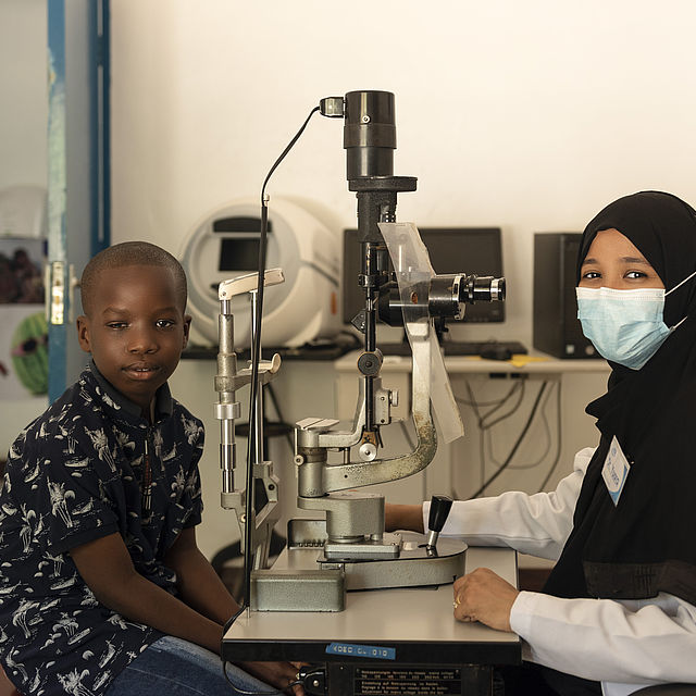 A female doctor is examining a 9-year-old boy Kassim at Kwale Eye Hospital in Kenya. 